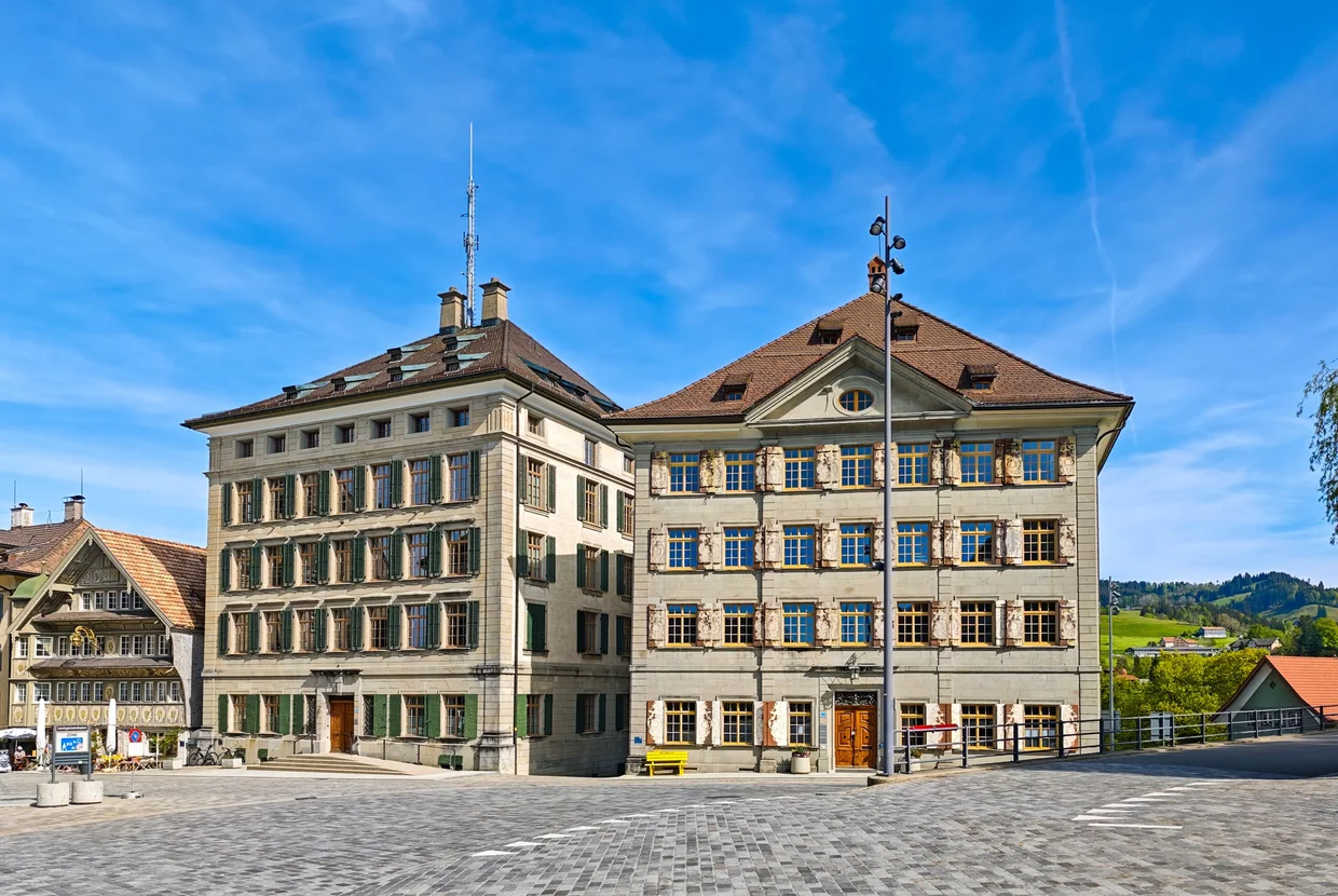 A pair of grand merchant mansions facing the square