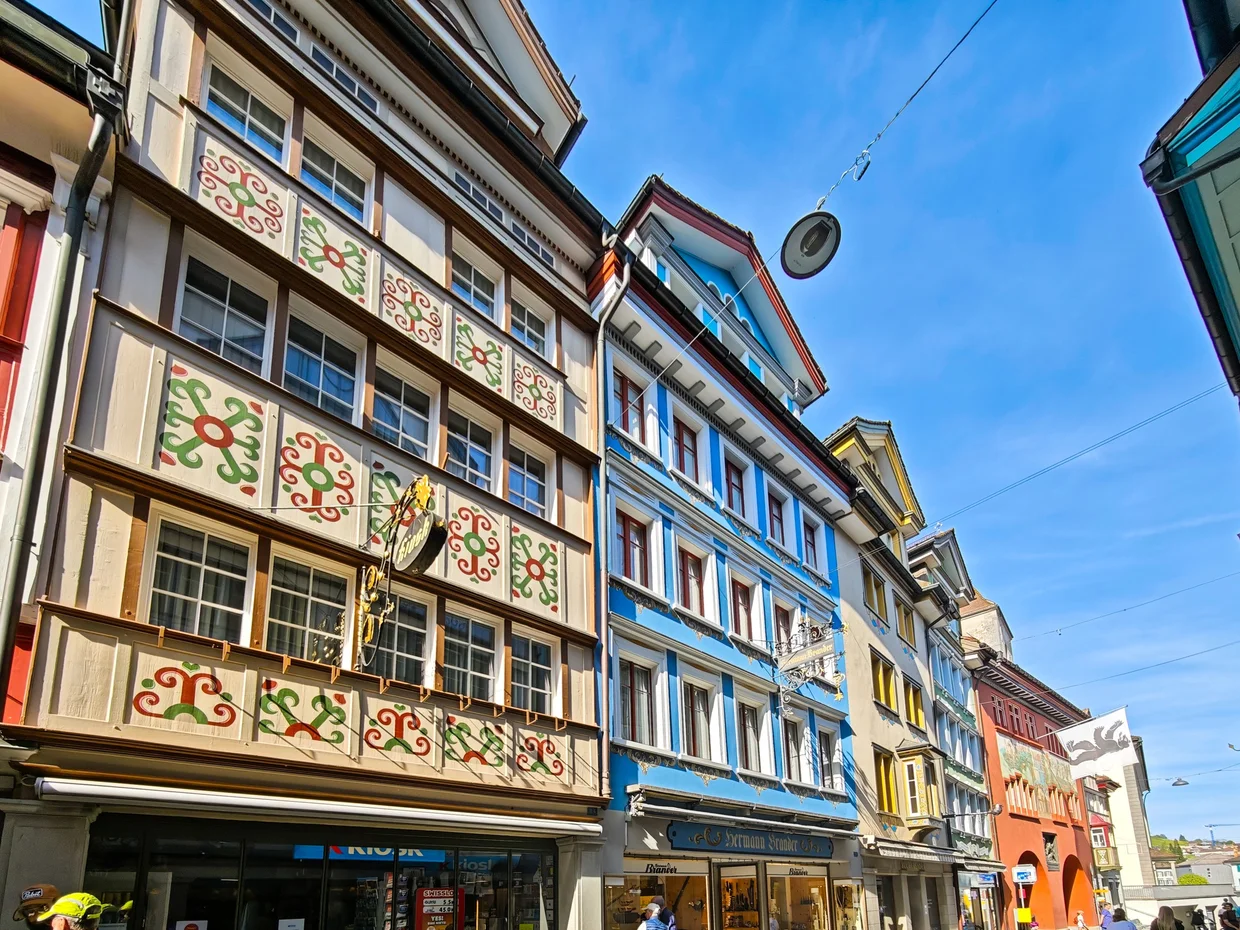Close-up of a colourfully painted bay window with green and red floral patterns