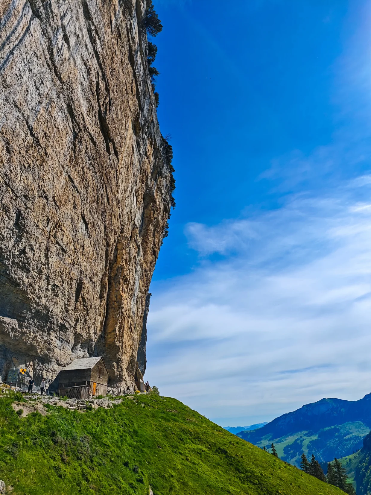 Aescher hut from the side showing the full sweep of the cliff above