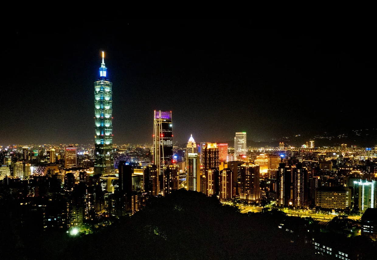 Taipei 101 rising above the city at night, seen from Elephant Mountain