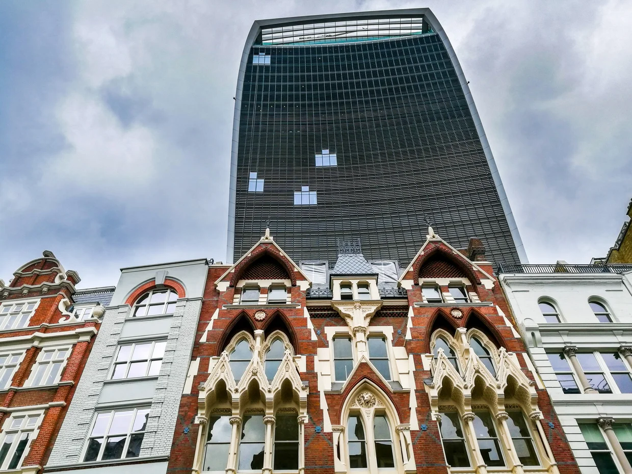 Red brick Victorian Gothic facades dwarfed by the Walkie Talkie behind